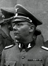 A black-and-white profile image of a Nazi officer. He wears glasses and full dress uniform, and a dueling scar is visible on his cheek.